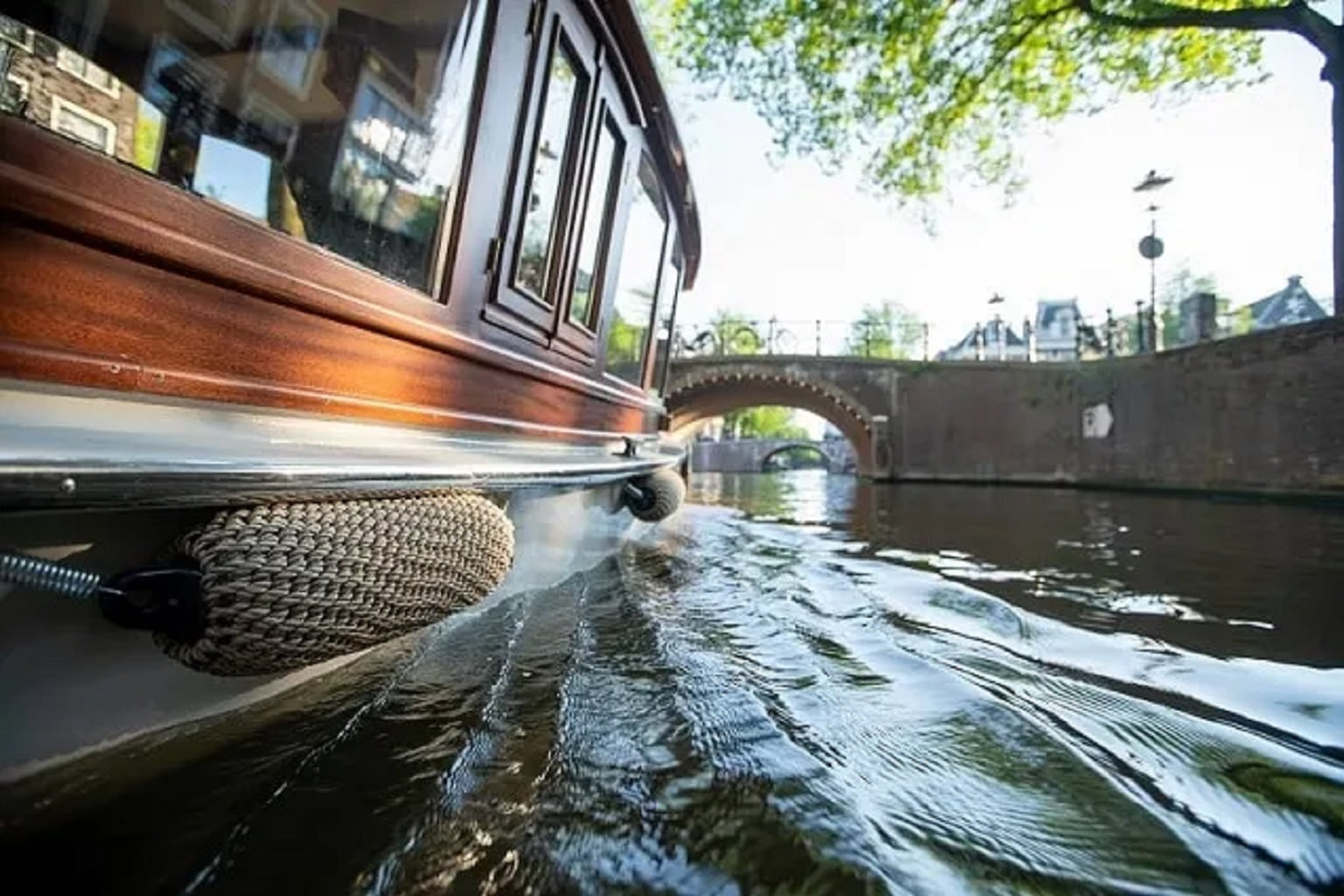 Undine, a historic 1920 saloon boat, cruising an Amsterdam canal
