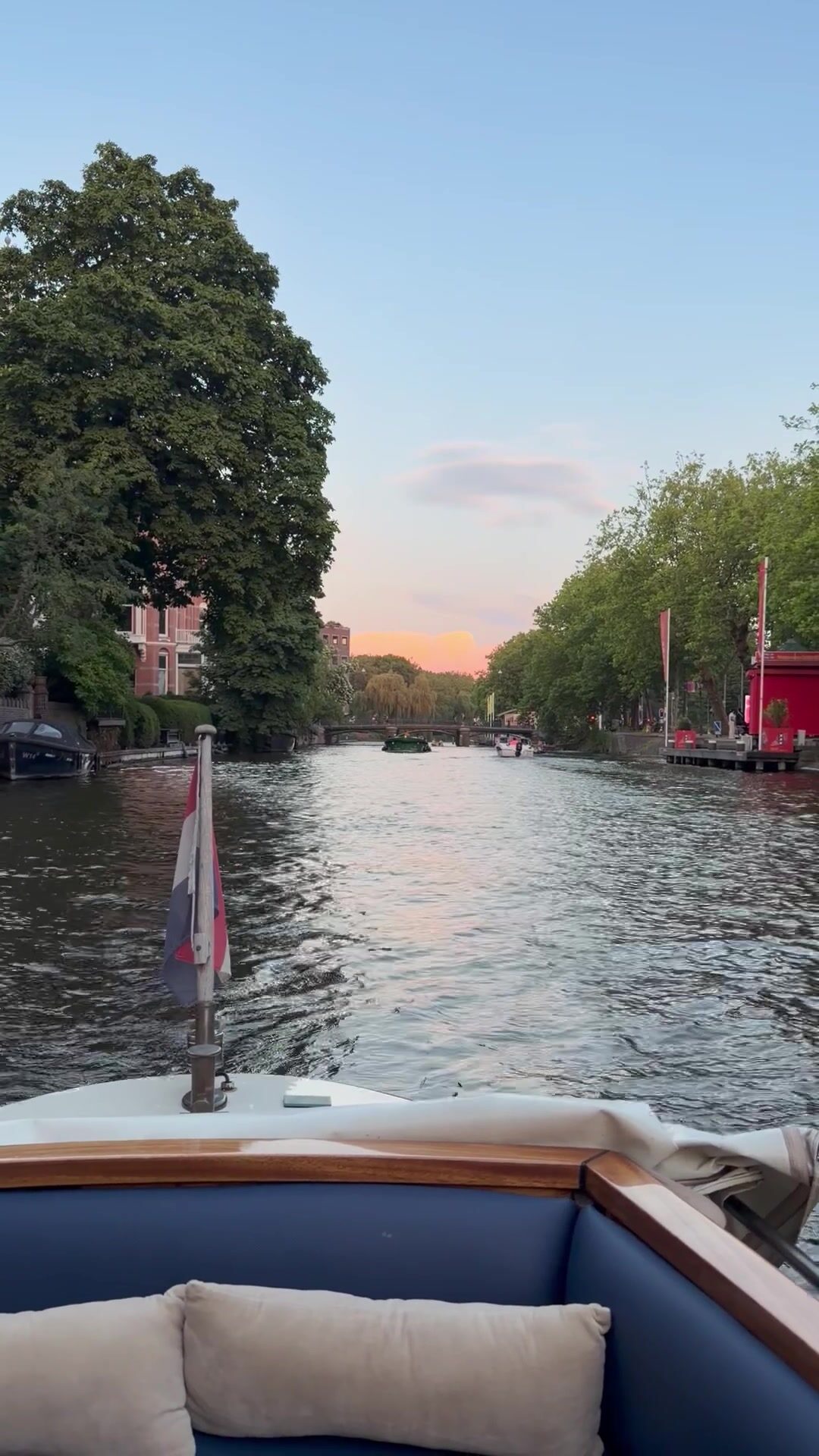 Sunset view down the Amstel River from a private Amsterdam countryside cruise boat